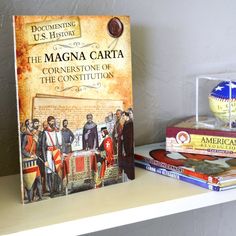 a book sitting on top of a white shelf next to other books and knick - knacks