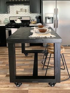 a kitchen island with two stools in front of it