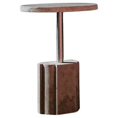 a brown and white table with a metal pole on it's side, against a white background