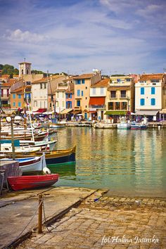 several boats are docked in the water next to buildings