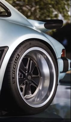 the front wheel of a silver sports car