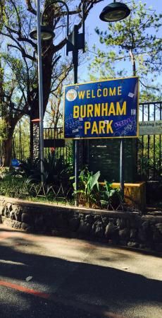 the welcome sign to burnham park is posted in front of a fenced area