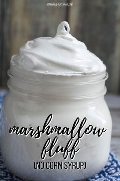 a jar filled with whipped cream sitting on top of a blue and white towel next to a