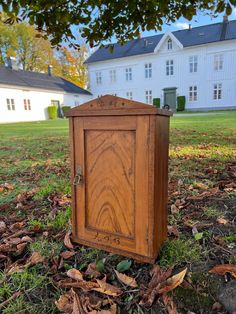 an old wooden box sitting in the grass