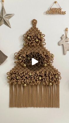 a christmas tree decoration hanging on the wall next to other ornaments and decorating items