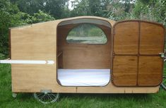 a small wooden trailer with its door open