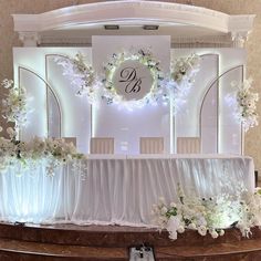 an elegant wedding setup with white flowers and greenery