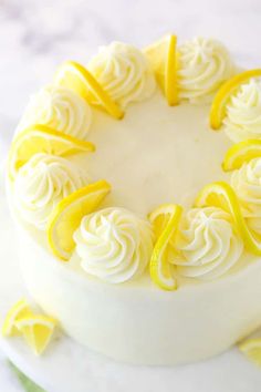 a white cake with lemons and icing on top