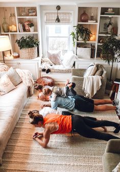 two people laying on the floor in front of a couch