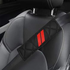 the interior of a car with black leather and red stitching on the front seat