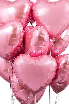 a bunch of pink heart shaped balloons