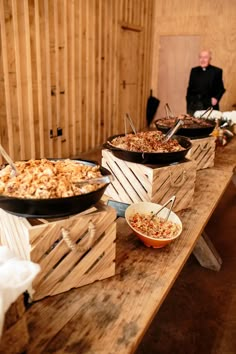 several bowls of food are lined up on a table