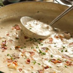 a large pot filled with some type of food and a spoon in it's side