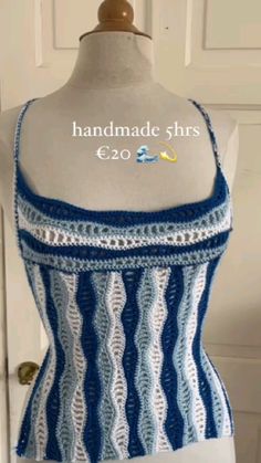 a mannequin wearing a blue and white top with crochet on it