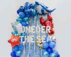 balloons and streamers are arranged in the shape of a circle with an ocean theme