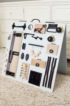 an assortment of items are displayed on the floor in front of a white dresser with drawers