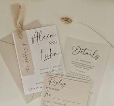 the wedding stationery is laid out on top of each other