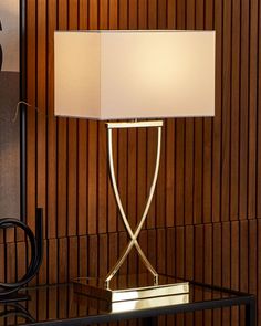 a table lamp sitting on top of a glass table