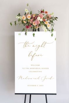 a sign with flowers on it that says the night before to the bride and groom