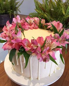 a white cake with pink flowers on top