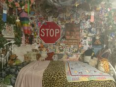 a bedroom with lots of stuffed animals on the wall and pictures all over the walls