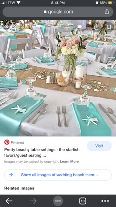 the table is set with silverware and blue napkins for an ocean themed wedding