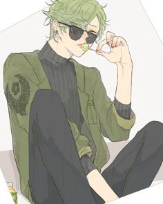 a man with green hair and sunglasses sitting on the ground holding something in his hand