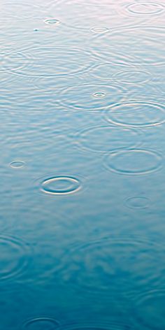 water ripples on the surface of a body of water with blue sky in the background