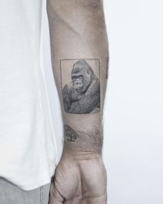 a man with a gorilla tattoo on his arm