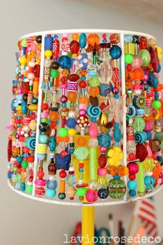 a lamp made out of beads and other colorful objects