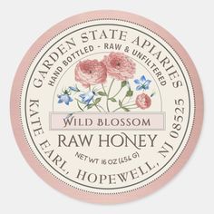 the label for wild blossom raw honey is shown in pink, white and blue colors