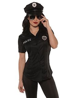 a woman dressed as a police officer is talking on her cell phone while posing for the camera