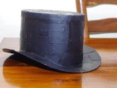 a black hat sitting on top of a wooden table