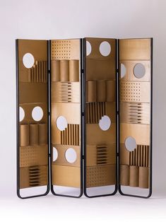 a room divider made out of cardboard with circles and holes on the sides,