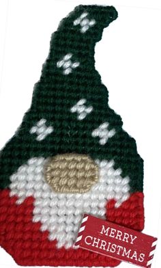 a knitted christmas ornament with a santa hat on it