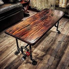 a coffee table made out of pipes and wood