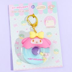 a keychain with a pink and blue donut on it's side