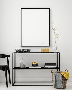 a white room with black furniture and a large poster hanging on the wall above it