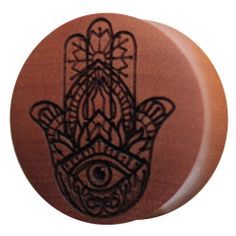 a wooden button with an image of a hamsa hand