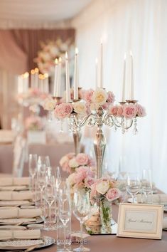 an elegant table setting with flowers and candles