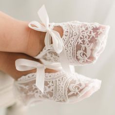 Light Ivory Lace Booties | Baby Beau & Belle These darling booties are the perfect complement to any look. Crafted with delicate light ivory lace and stunning detailing, soft ivory silk ribbon ties give them a snug, polished finish with a vintage appeal. ~  Light ivory lace ~  Ivory silk ribbon ties ~  Designed in House & Imported ~  Includes - Booties Only  Sizing 0-3 months - Foot up to 3.5 inches 3-6 months - Foot up to 3.75 inches 6-9 months - Foot up to 4 inches 9-12 months - Foot up to 4.2 Spring White Booties As Gift, Elegant White Booties For Spring, Elegant White Spring Booties, Elegant Lace-up Booties For Spring, Elegant Wedding Booties With Round Toe, Elegant White Booties With Round Toe, Elegant White Round Toe Booties, Blessing Gown, Crib Shoes Girl