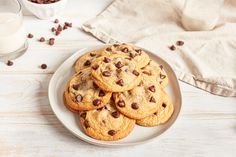 chocolate chip cookies on a plate next to a glass of milk