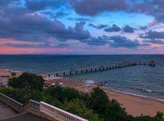 an ocean view with a pier in the distance