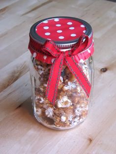 a glass jar filled with nuts on top of a wooden table