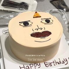 a birthday cake with a face drawn on it