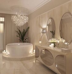 an elegant bathroom with chandeliers and candles on the countertop, along with a round bathtub