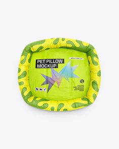 a green and yellow pet pillow with stars on it's sides, sitting in front of a white background