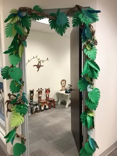 a doorway decorated with paper leaves and monkeys