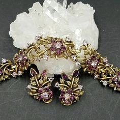 Absolutely Stunning Vintage Coro "Navarre" ( 1956) Bracelet And Earring Set In Antique Gold Tone Metal Set With Amethyst And Lilac Rhinestones. Each Panel On The Bracelet Is An Open Work Design Of Leaves Set With A Central Rhinestone Flower. The Bracelet Measures 7 By 7/8". The Matching Clip Earrings Are 1 3/8 By 1 1/8". All Pieces Signed Coro. Fabulous Condition! Coro Jewelry, Bracelet And Earring Set, Piece Sign, Work Design, Rhinestone Flower, Purple Lilac, Clip Earrings, Purple Gold, Gold Tone Metal