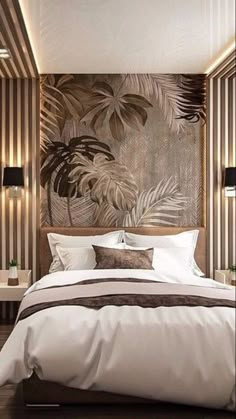 a large bed sitting in a bedroom next to a wall with palm leaves on it